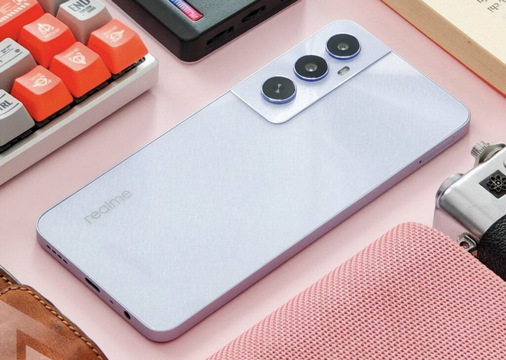 Realme C65 Teased Sleek Design and Near Launch 2 A sleek, modern realme c65 with a triple camera setup lies on a pastel surface surrounded by trendy accessories, showcasing a lifestyle of technology and style.