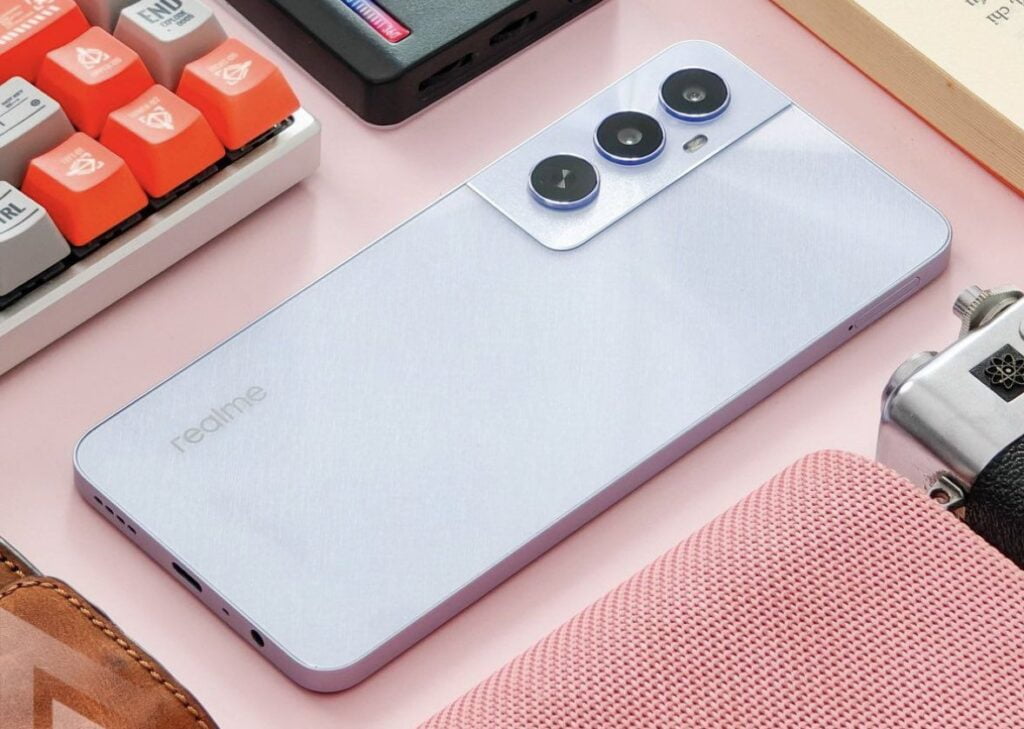 A sleek, modern realme c65 with a triple camera setup lies on a pastel surface surrounded by trendy accessories, showcasing a lifestyle of technology and style.