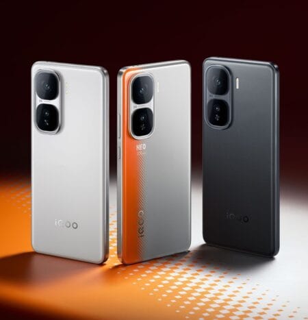 Three iQOO Neo 10 smartphones are displayed, angled slightly towards the viewer. The phones are shown in silver, orange-gradient, and dark gray. They are positioned on an orange and white checkered surface.