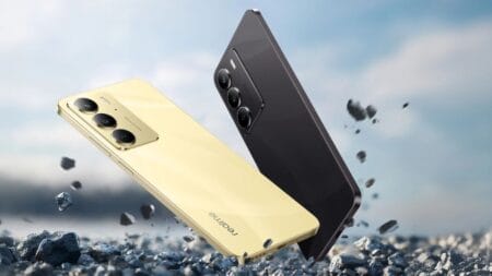 Two Realme C75 smartphones, one gold and one black, are shown falling amidst small rocks, emphasizing their rugged and durable design.