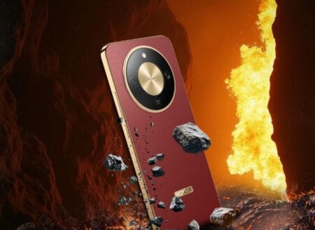 Close-up of the Honor X9d phone showcasing its circular camera module and textured red back, floating amidst volcanic rocks and flames.