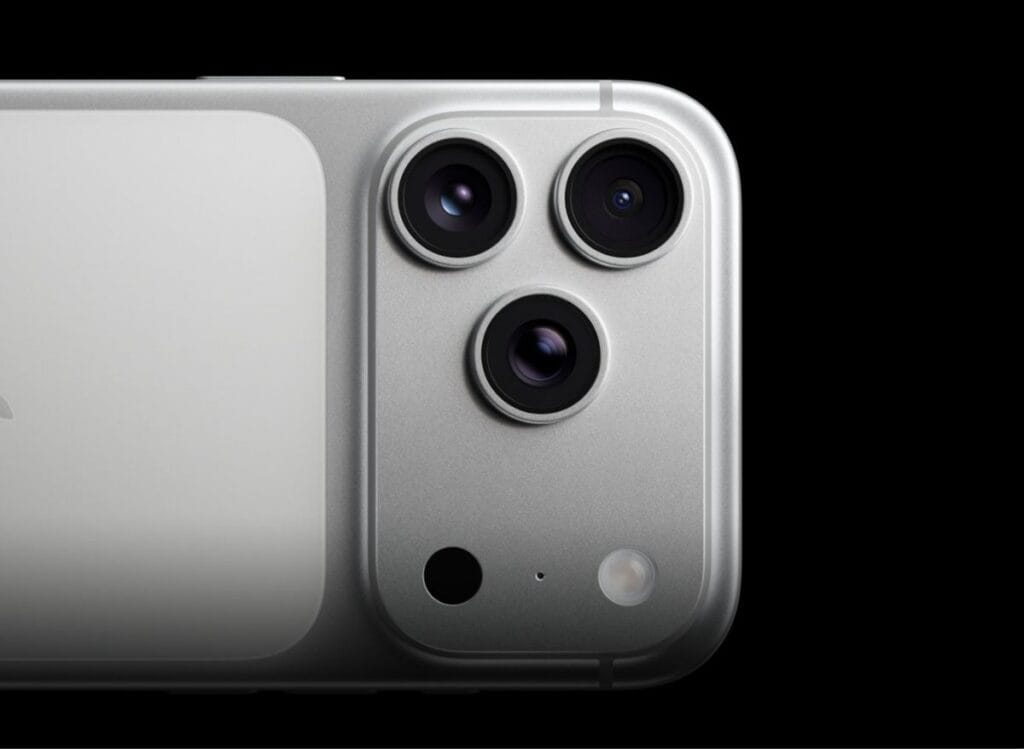 iPhone 17 Pro Max Camera | Triple 48MP Cameras and Professional Video Upgrades 1 Close-up of the iPhone 17 Pro Max's silver finish with its triple-lens camera system, microphone, and flash, set against a stark black background.