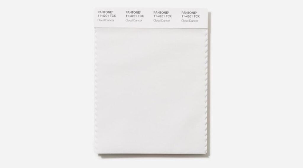 Pantone Announces Color of the Year 2026: Cloud Dancer (PANTONE 14-4207) 1 Close-up of a Pantone textile color swatch in 'Cloud Dancer' (11-4201 TCX), shown against a white background.