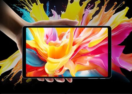 Close-up of a person's hand displaying the Teclast T50 Mini tablet. The screen shows a colorful abstract image of swirling paint, highlighting the tablet's bright and vivid display.