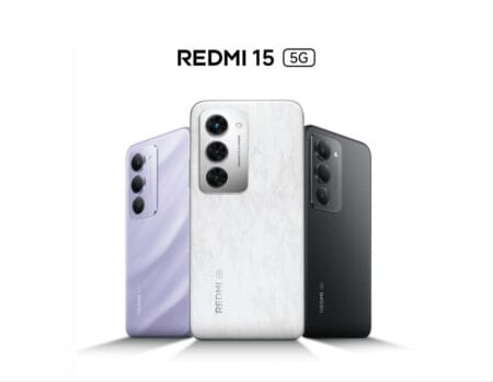 Three Redmi 15 5G smartphones in different colors (lavender, white marble, and black) are standing side-by-side against a white background, showcasing the rear design with vertically aligned camera modules.