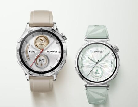Close-up product shot showcasing two Huawei Watch GT5 smartwatches. The watch on the left features a beige silicone band and a classic watch face. The watch on the right has a light green, textured band and a more modern, geometric watch face.