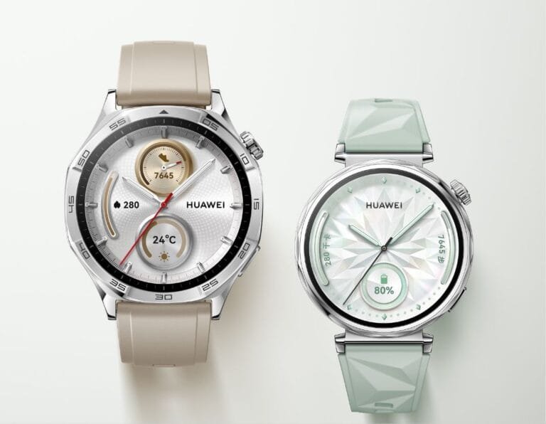 Close-up product shot showcasing two Huawei Watch GT5 smartwatches. The watch on the left features a beige silicone band and a classic watch face. The watch on the right has a light green, textured band and a more modern, geometric watch face.