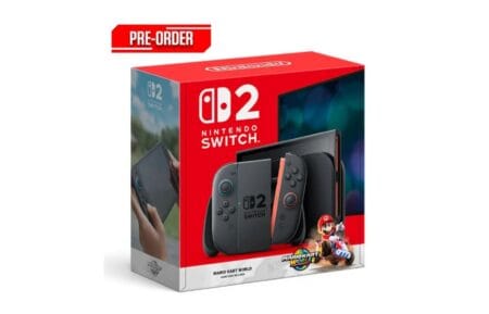 A product shot of the Nintendo Switch 2 Mario Kart World bundle. The box art features a dark gray Nintendo Switch 2 console, detached Joy-Cons, and Mario Kart imagery. A "Pre-Order" banner is prominently displayed at the top.