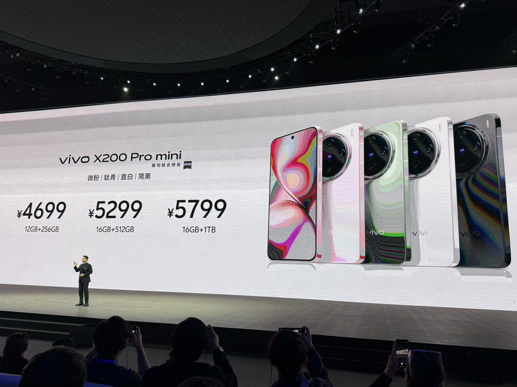 a person in a stage event presenting the features and price of the vivo x200 pro mini