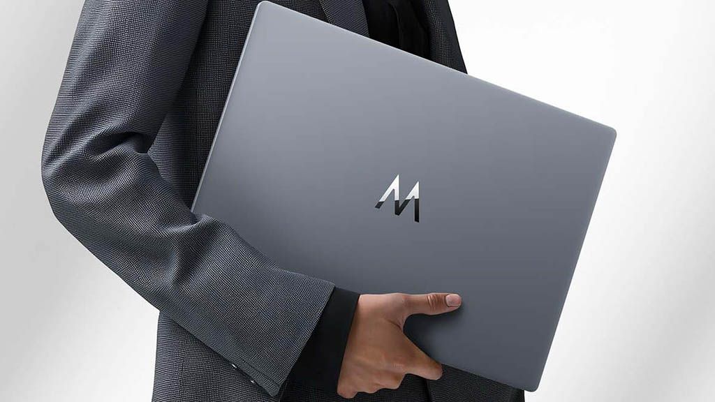 a person holding the wiko hi matebook d16 laptop