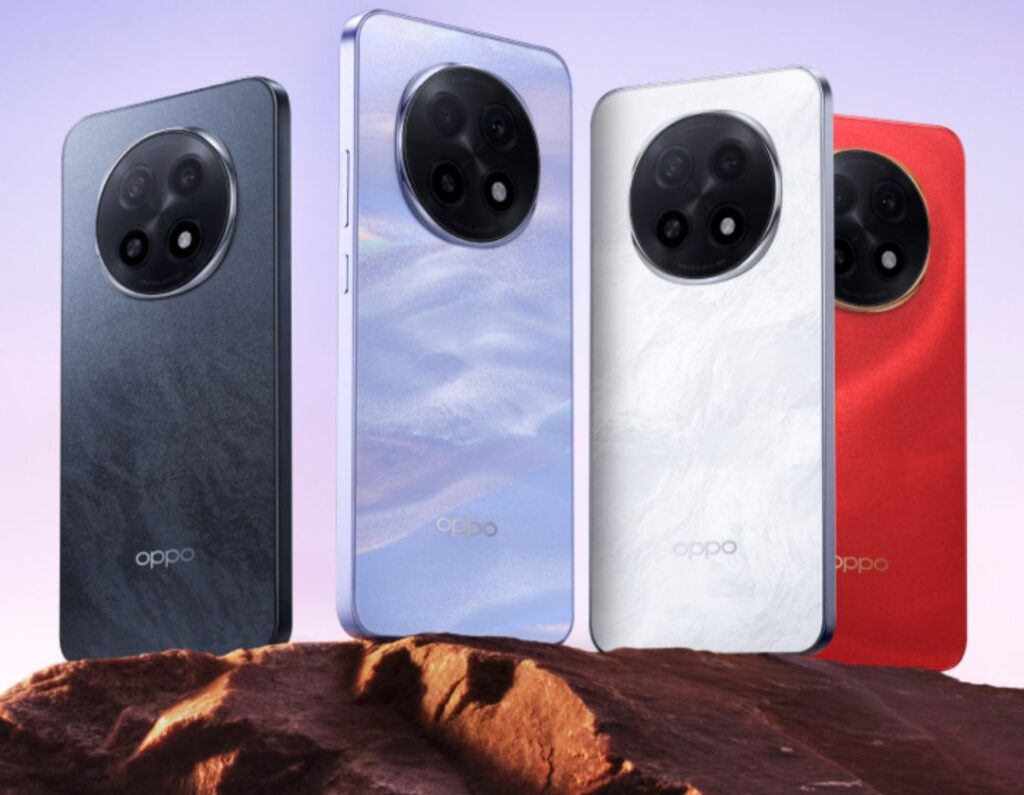 Four Oppo A5 Pro 5G smartphones displayed on a rock, showcasing their different color options: dark gray, light purple, white, and red. Each phone features a circular camera module on the back.