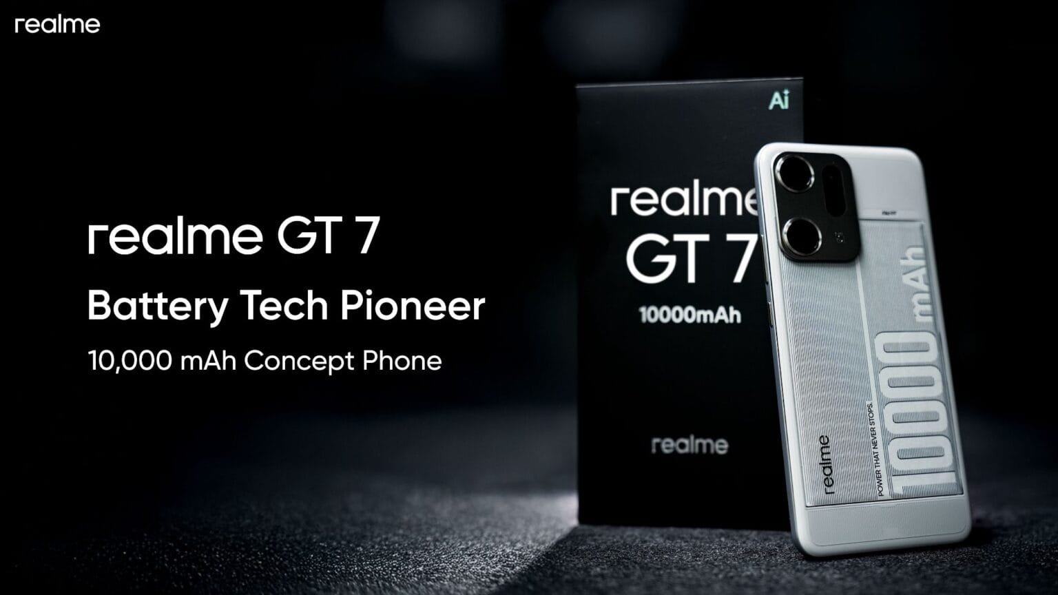 A product shot of the Realme GT 7 concept phone, showcasing its sleek silver design and prominently featuring a large "10000mAh" battery indicator on the back. The phone is displayed next to its box, both bearing the Realme branding. The background is dark, emphasizing the phone's design.