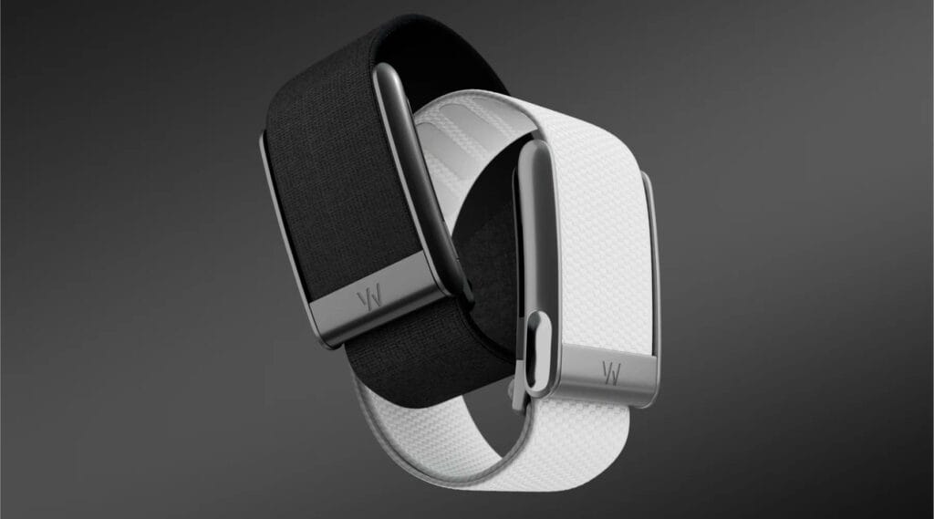 WHOOP Unveils Whoop 5.0: A Major Upgrade to its Wearable Health Tracker 1 Two Whoop 5.0 wearable fitness trackers shown, one with a black band and one with a white band. Both feature a dark gray metallic clasp with the Whoop logo.