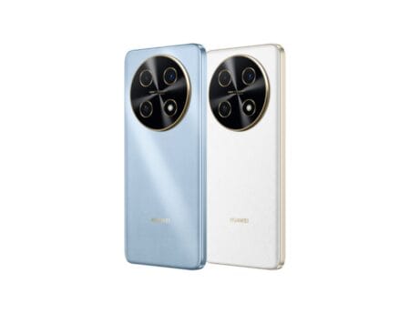 Two Huawei Nova 13i smartphones are shown from the back. One is light blue, the other is white. Both phones feature a prominent circular camera module with multiple lenses and a gold accent ring. The Huawei logo is visible at the bottom of each phone.