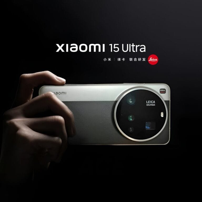 Xiaomi 15 Ultra Global Launch on March 2, 2025 A hand holds up a Xiaomi 15 Ultra smartphone, showcasing its large, circular Leica camera module. The phone is light gray or silver, and the background is black. The Xiaomi 15 Ultra branding is visible at the top.