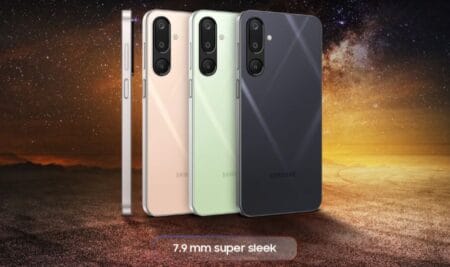 Three Samsung Galaxy M16 5G smartphones displayed from the back, showcasing their sleek 7.9mm design and available in light beige/gold, light green/mint, and dark gray/graphite colors. The phones are set against a backdrop of a starry night sky and a desert landscape.