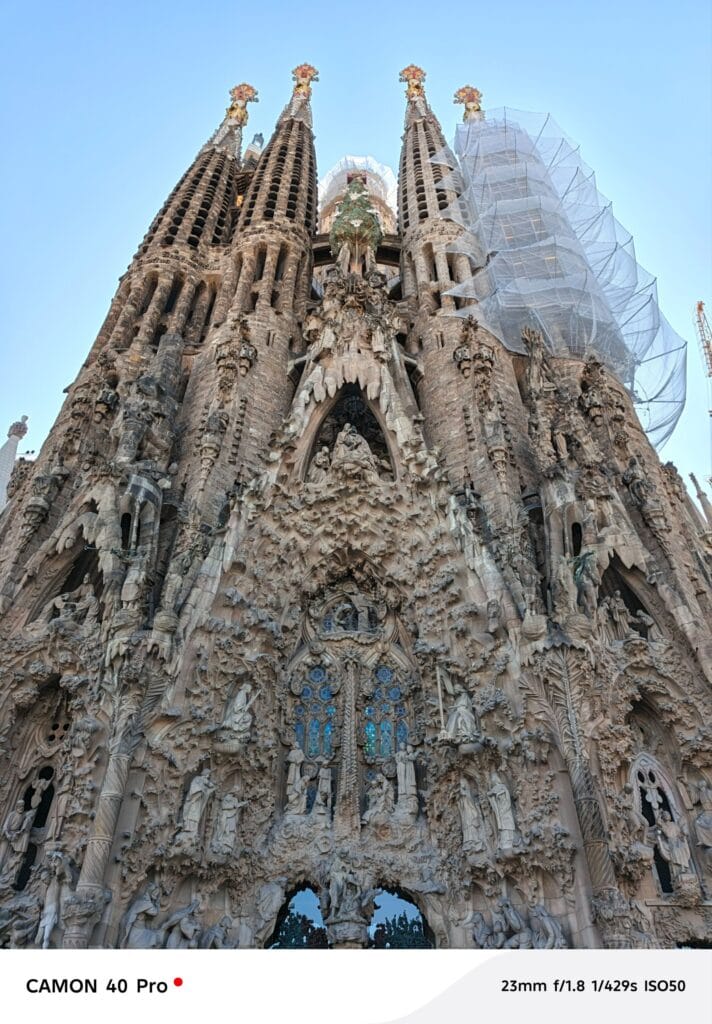 Tecno Camon 40 Pro 5G DXOMARK Global Ranking #1 Under $600 3 A detailed, low-angle photograph of the intricately carved facade of the Sagrada Familia basilica in Barcelona. Parts of the building are covered by protective netting. The photo was taken with a Tecno Camon 40 Pro.