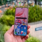 Honor 500 Series Spotted on 3C Certification with 80W Fast Charging 5 A hand holds an Honor smartphone with a pink and white gradient wallpaper. The screen displays the time as 17:03 and the date as Friday, July 11th. App icons for YouTube, Instagram, Telegram, and Google Play Store are visible.