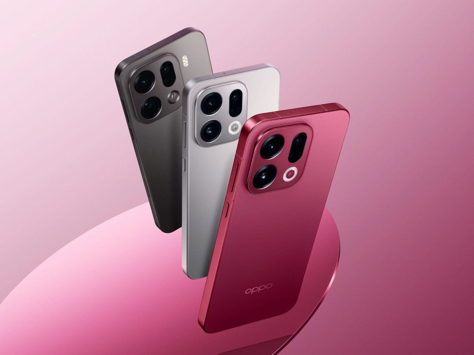 Three Oppo Find X9 phones in different colors (grey, silver, and red) arranged on a pink background, showcasing the new design.