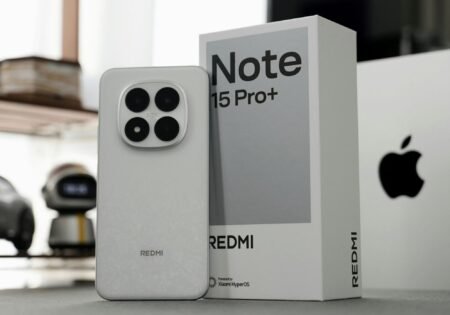 Redmi Note 15 Pro+ Spotted on Geekbench, Hinting at Global Launch Image of the Redmi Note 15 Pro+ beside its packaging, highlighting the phone's camera module and branding.