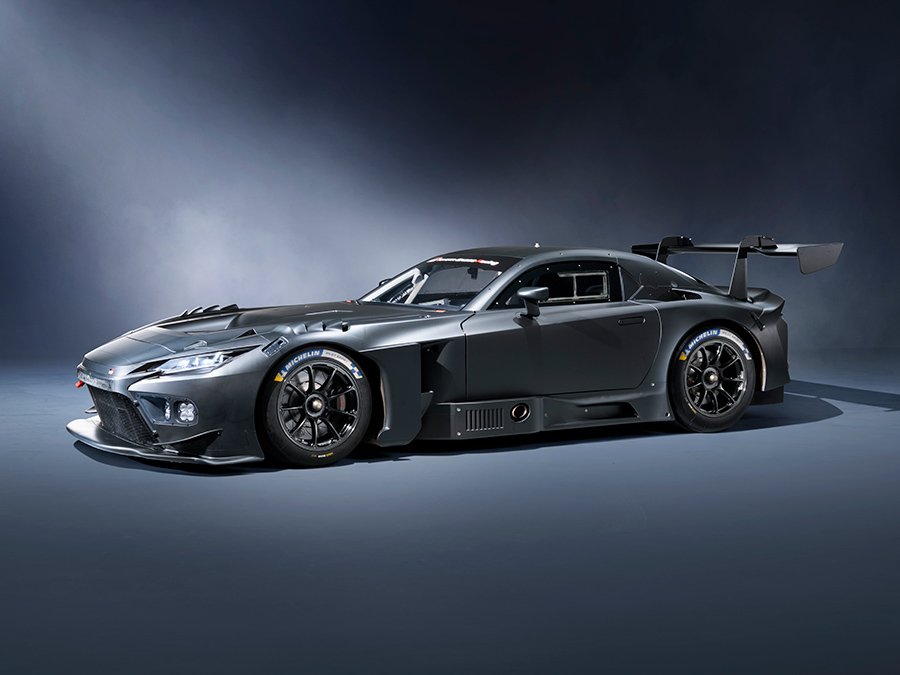 Toyota Gazoo Racing’s New GR GT3 Turns Heads as It Gears Up for Racetracks and Roads A sleek, matte black race car with aerodynamic bodywork, large rear wing, low stance, and racing tires, designed for high performance on the track.
