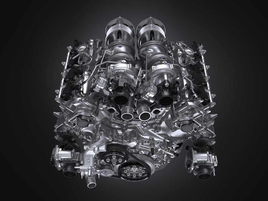 Toyota Gazoo Racing’s New GR GT3 Turns Heads as It Gears Up for Racetracks and Roads 2 A close-up, highly detailed image of a twin-turbo V8 engine, showcasing its polished metallic surface, twin turbochargers at the top, various pipes, and intricate components against a dark background.