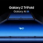Image of the Samsung Galaxy Z TriFold partially unfolded, displaying its large blue screen and carbon fiber-like texture on the outer panels. The 'Galaxy AI' logo is visible on the screen.