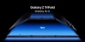 Image of the Samsung Galaxy Z TriFold partially unfolded, displaying its large blue screen and carbon fiber-like texture on the outer panels. The 'Galaxy AI' logo is visible on the screen.
