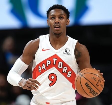 RJ Barrett, Toronto Raptors player currently sidelined with a knee injury, in a game photo.