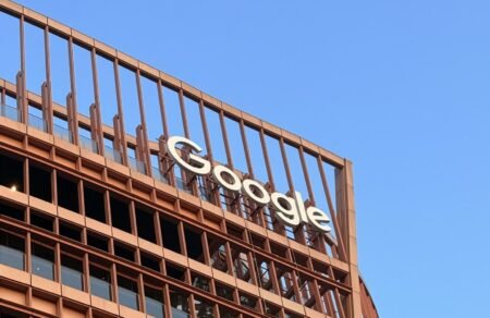 Google Faces EU Antitrust Probe Over AI Overviews Using Publisher Content The Google logo on a building, illustrating the company's presence as it faces an EU antitrust probe.