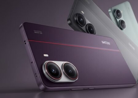 Product render of the Redmi Turbo 5 Pro smartphone, showcasing three color variants. In the foreground is a deep purple model with a textured back, a thin red accent line, and a dual-camera module with silver rings and red trim. Behind it are a matte gray variant and a light teal variant, both featuring the same dual-camera design. The 'REDMI' logo and '5G' text are visible on the purple model’s back.