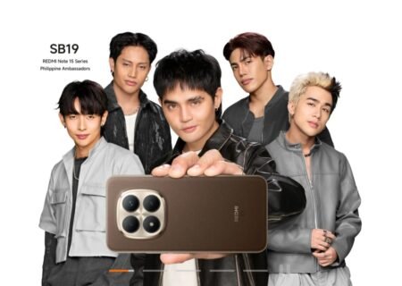 Filipino boy group SB19, named as Philippine Ambassadors for the Redmi Note 15 Series, pose together against a white background. One member holds up a brown Redmi Note 15 smartphone, displaying its quad-camera module with a metallic frame. Text in the top-left corner reads: 'SB19 – REDMI Note 15 Series Philippine Ambassadors'.