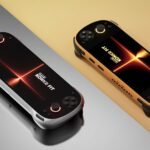 Two KONKR FIT handheld gaming consoles, one in Luminous Silver and one in Dragonveil Gold, resting on a split-tone reflective surface.