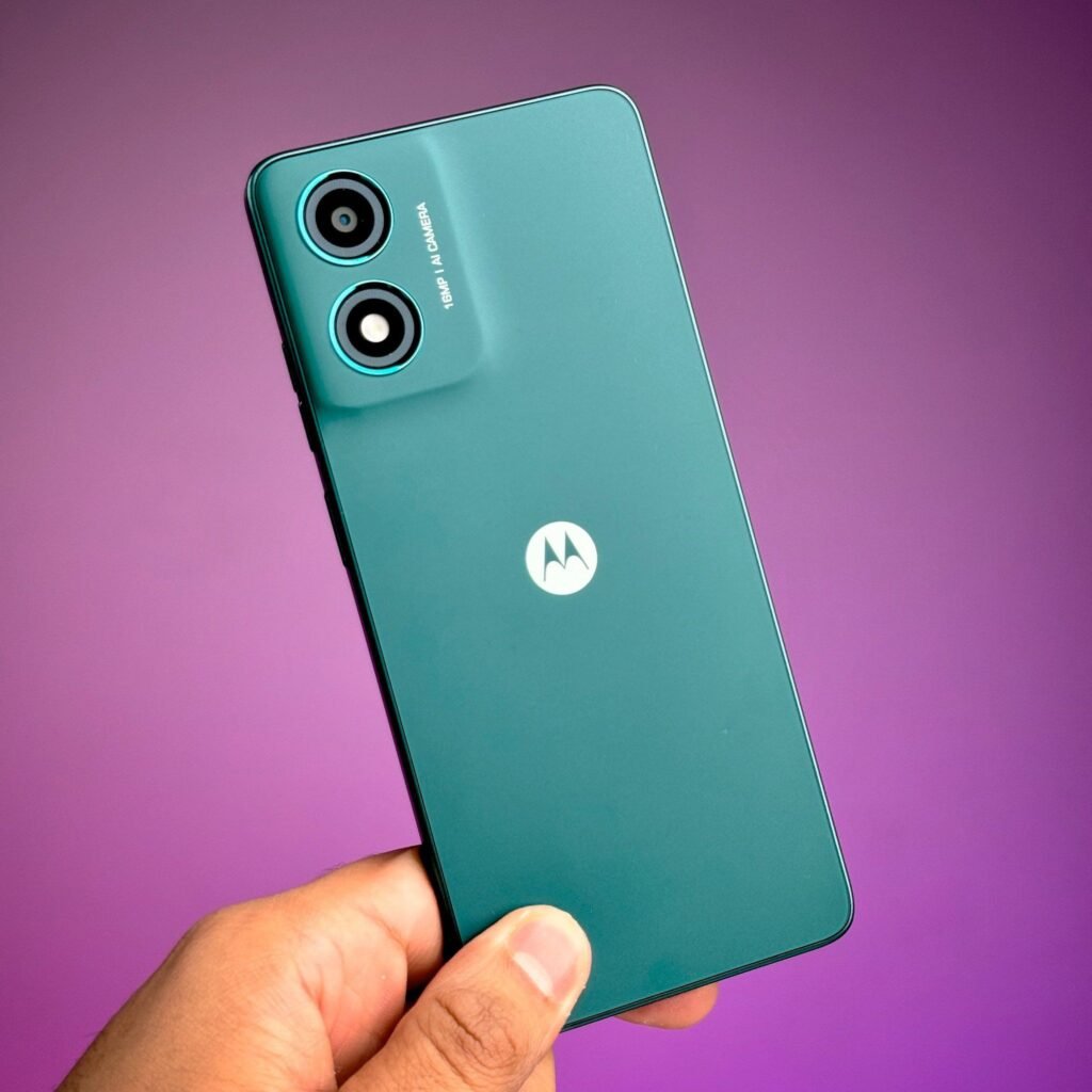 holding a motorola moto g04 with blue green variant
