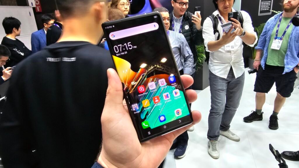 Holding a rollable smartphone whic is the tecno phantom ultimate