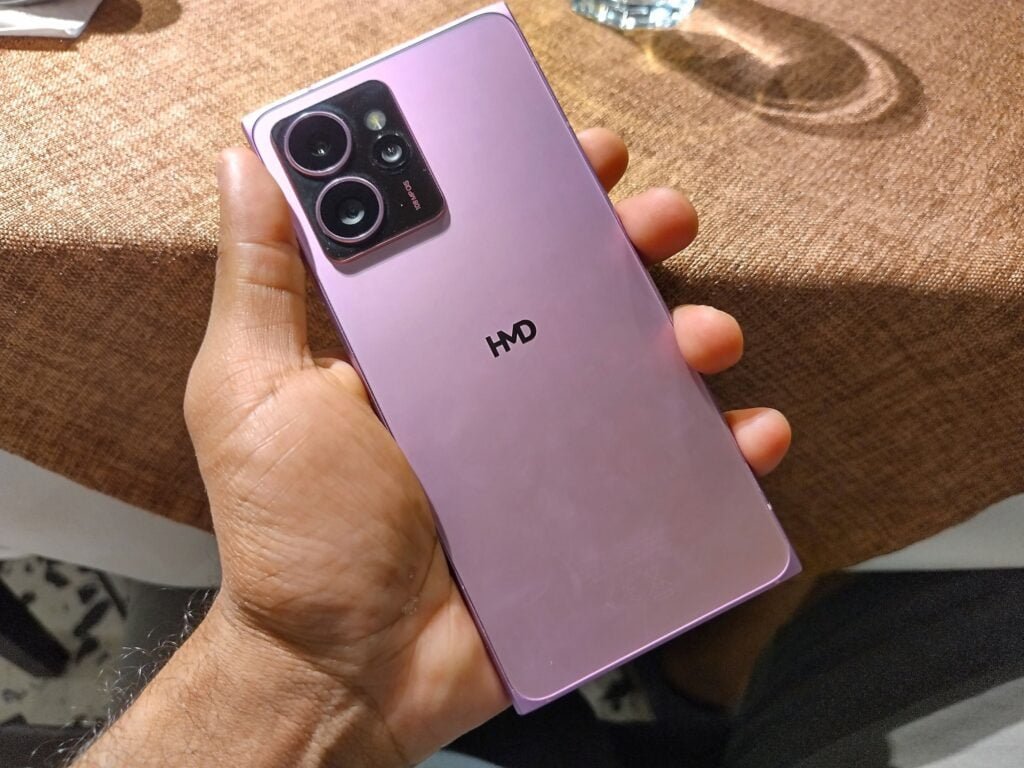 a person holding the hmd skyline 5g smartphone