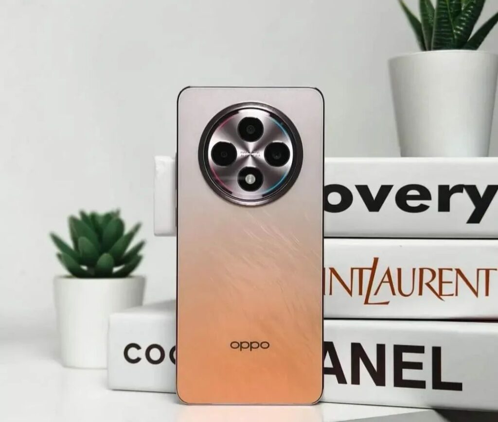 A Phone Oppo Reno 12F 5G In Color Orange Scheme With Books In The Background