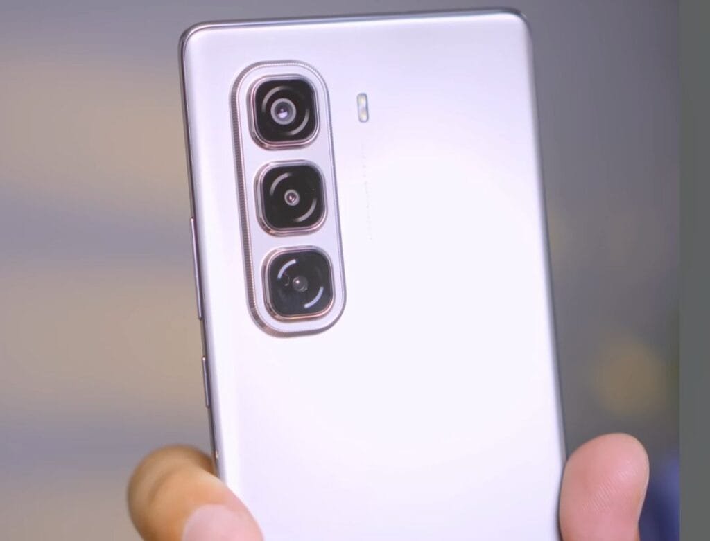 a person holding the infinix hot 50 pro+ 5g with vertical camera island along-side is an LED flash