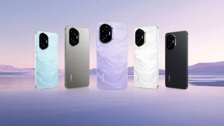 Honor 300 Ultra Launched with Under-Clocked Snapdragon 8 Gen 3, 50MP Camera, and 100W Charging Five Honor 300 Ultra smartphones are displayed against a serene landscape backdrop. Each phone showcases a different color: light blue, silver, light purple, white, and black. The phones are positioned slightly apart, reflecting on a calm body of water in the foreground. The background features a soft, purplish-pink sky and gently rolling hills.