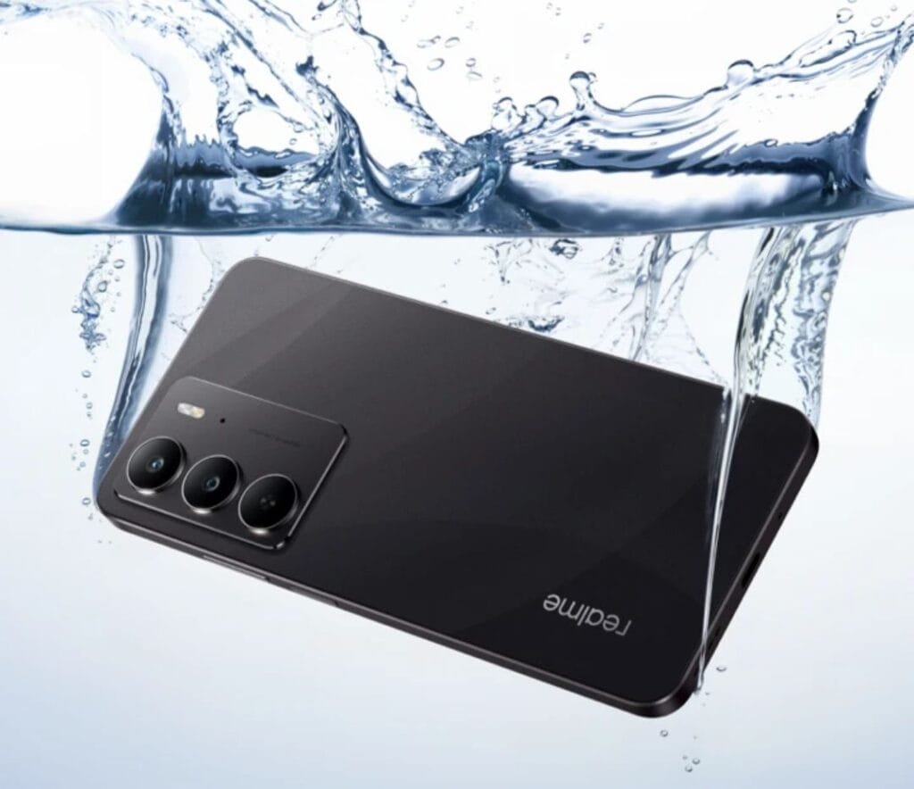 Realme C75 Smartphone Arrives in PH w/ IP69 Rating and MediaTek Helio G92 Max Product shot of a black Realme C75 smartphone partially immersed in water. Water droplets and splashes surround the phone, emphasizing its water-resistant design and features. The phone's camera module is clearly visible. The Realme logo is visible on the back.