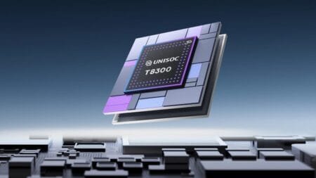 Unisoc T8300 5G SoC Launched: TSMC 6nm EUV Process with Satellite Connectivity A close-up, digitally rendered image showcases the Unisoc T8300 5G system-on-a-chip (SoC). The SoC is depicted as a layered, rectangular chip with a dark gray surface and accents of purple and light blue. The Unisoc logo and "T8300" are clearly visible on the chip's surface. The chip hovers above a detailed circuit board, suggesting its integration into a larger electronic system. The background is a gradient of dark blue, providing a clean and professional aesthetic.