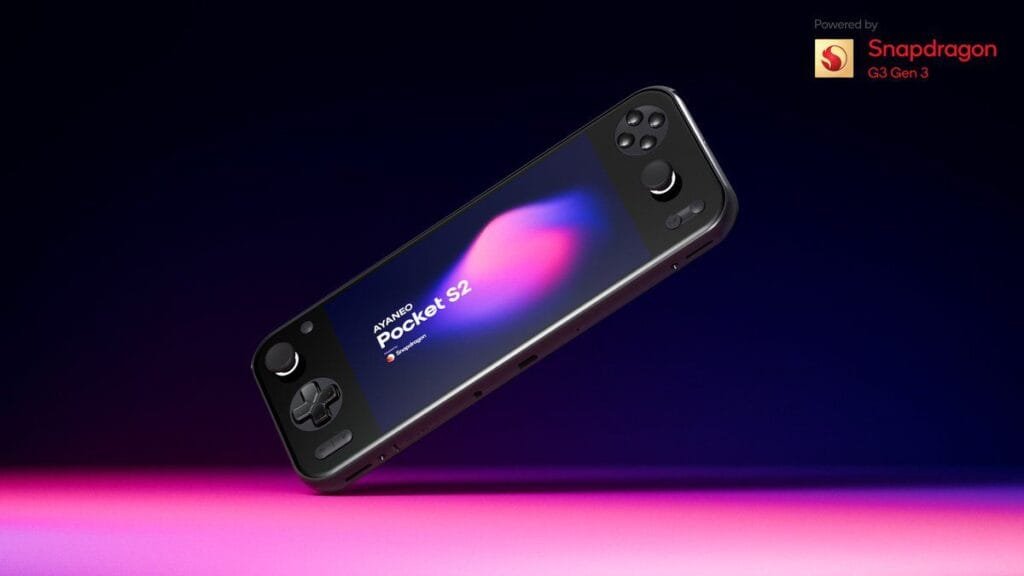 ‎A sleek, black Ayaneo Pocket S2 handheld gaming console is shown at an angle against a dark background with pink and purple lighting. The device's screen displays a vibrant abstract design, and the text "AYANEO Pocket S2" is visible. A small Snapdragon logo is also visible.