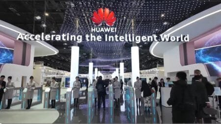 Huawei Smartphone Revenue Surges to $118 Billion in 2024 A vibrant display at MWC 2025 in Barcelona showcases Huawei's commitment to accelerating the intelligent world. The image highlights the Huawei brand and features attendees interacting with technology demonstrations, suggesting a focus on the latest Huawei smartphone innovations and advancements.