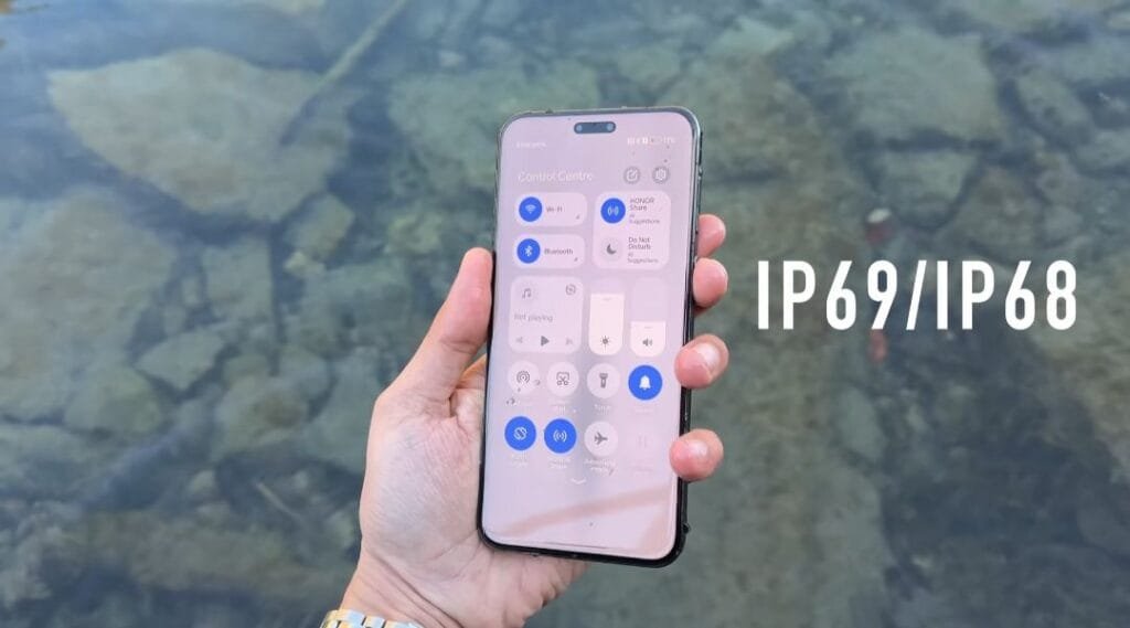 ‎A person tests the water resistance of a smartphone near a lake or river. The phone's screen shows its control center, and 'IP69/IP68' is displayed.