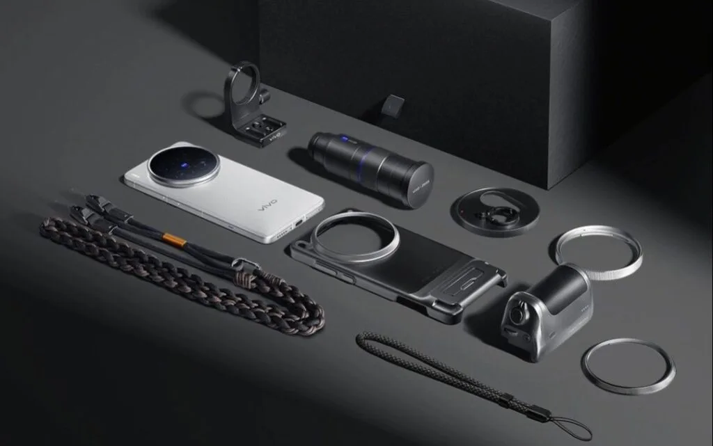 Vivo X200 Ultra Launched in China: 2K AMOLED Display, 50MP Sony LYT-818, and 200MP Periscope Telephoto 3 The Vivo X200 Ultra smartphone is displayed alongside its professional photography kit. The kit includes additional lenses, a phone case, straps, and other accessories designed to enhance the phone's photographic capabilities.