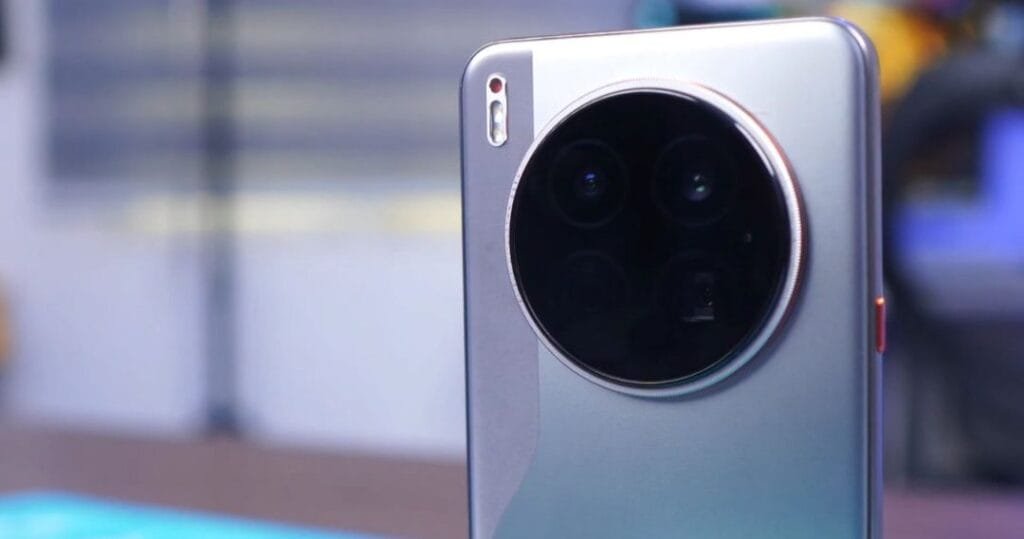 Detail shot of the Tecno Camon 40 Premier's camera array. The circular camera module features multiple lenses and is set against a light grey/silver phone back.