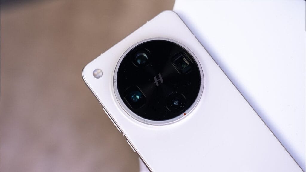 Detailed view of the camera module on a white smartphone (Oppo Find X8s+). The circular design features multiple lenses.