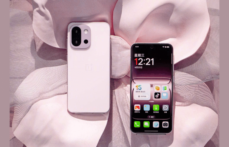 OnePlus 13T Launched in China: A Compact Phone with Snapdragon 8 Elite A close-up shot showcases the OnePlus 13T smartphone in a pale pink hue, set against a softly textured, blush-toned backdrop. The phone's back features a camera array with three lenses, while the front screen displays a clock reading 12:21. The overall aesthetic is clean and minimalist.