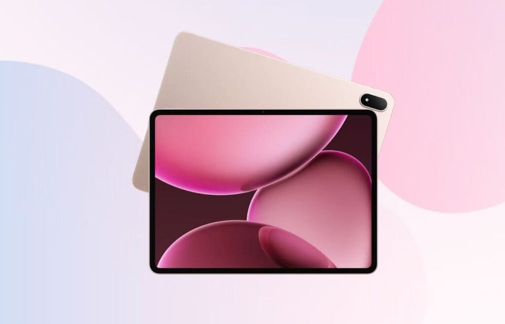 A gold Oppo Pad 4 Pro tablet is shown slightly tilted, showcasing its thin bezels and a screen displaying an abstract background of overlapping pink and maroon spheres against a dark background.