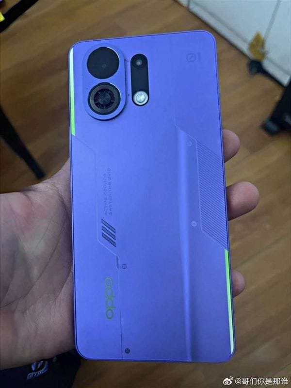 A person's hand displays the rear of the OPPO K13 Turbo Pro smartphone. The phone is a light purple color with a distinctive camera module and subtle design lines. A small green accent is visible along the edge. The OPPO logo is also visible.